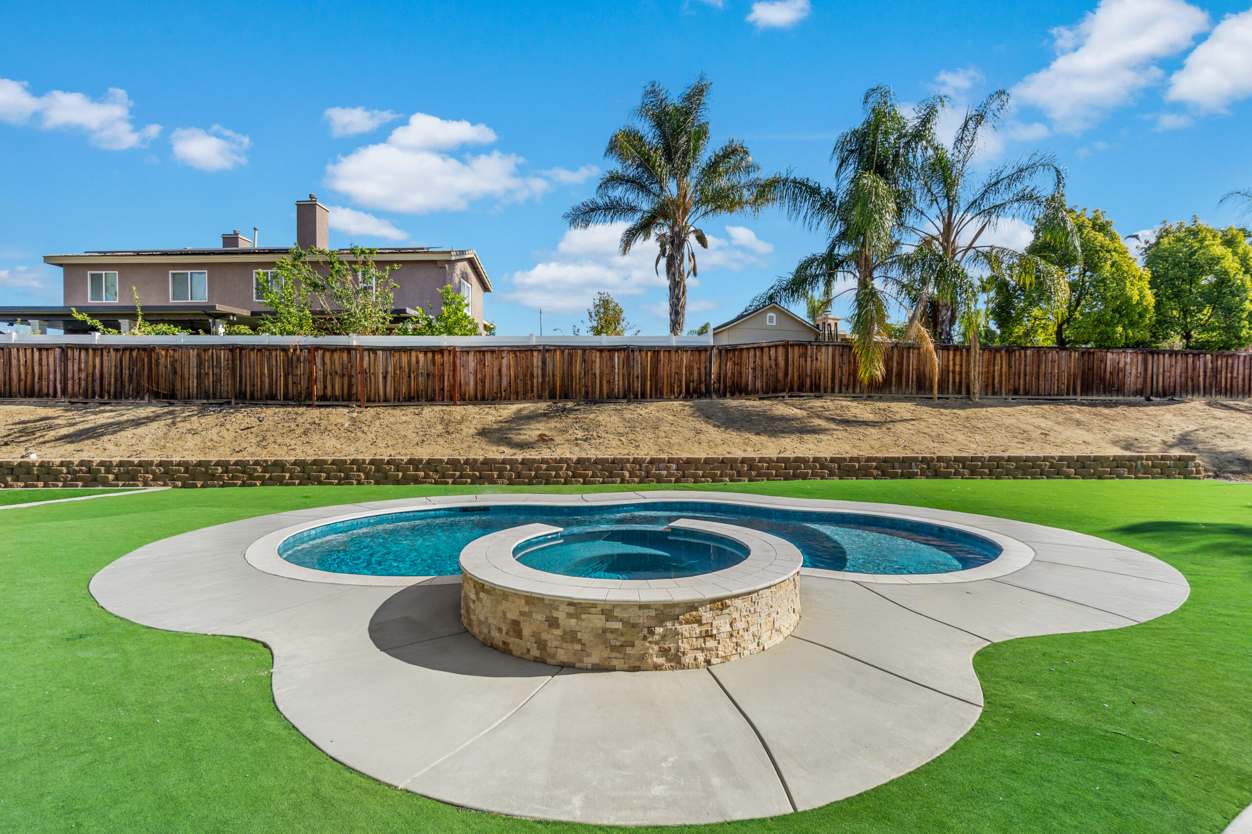 Backyard spa and pool with modern design and lush surroundings